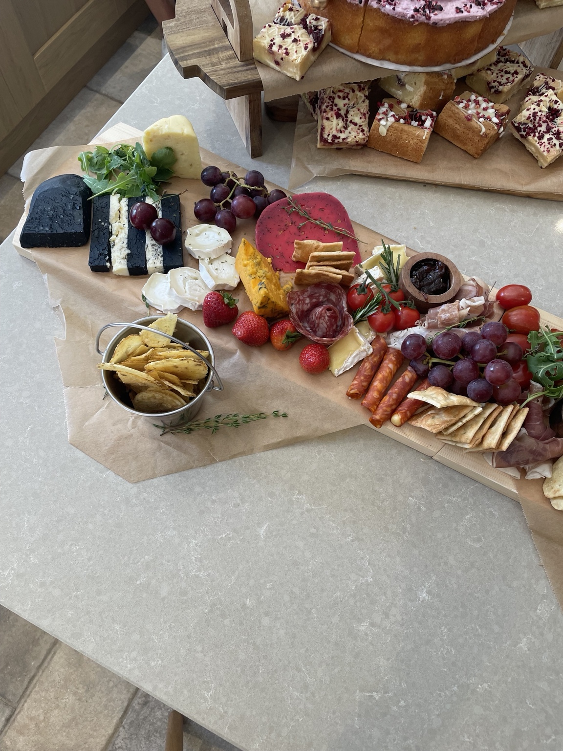 Cheese, charcuterie and cakes arranged for sharing