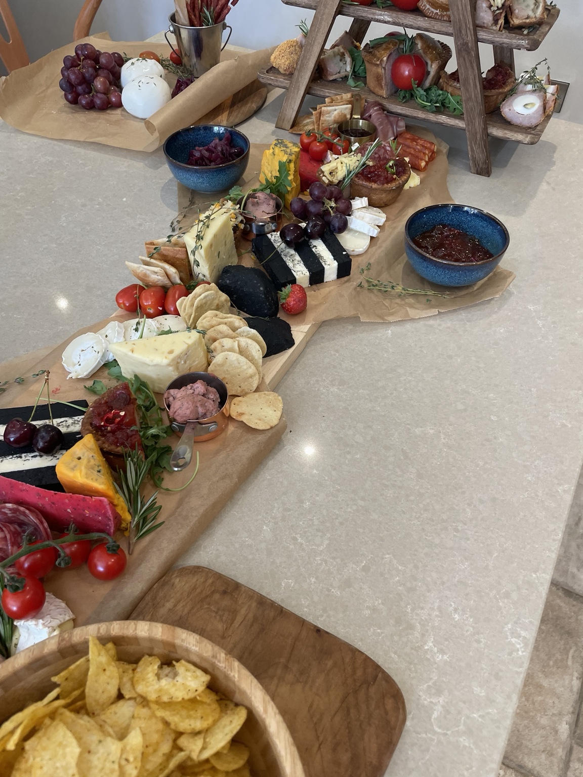 A colourful grazing table of cheese, charcuterie and savoury treats