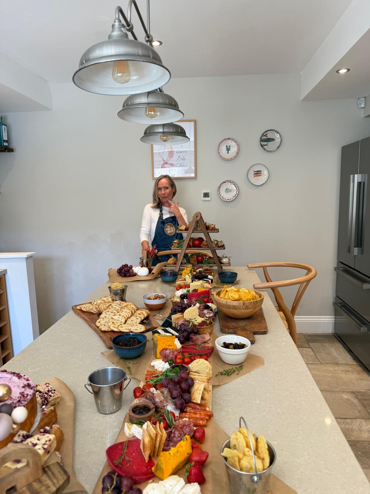 The Hideout outside catering grazing table filled with charcuterie, cheeses, fruit and sweet treats